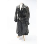 A mid-20th century black-finish horse-hide German policeman’s three-quarter length coat.