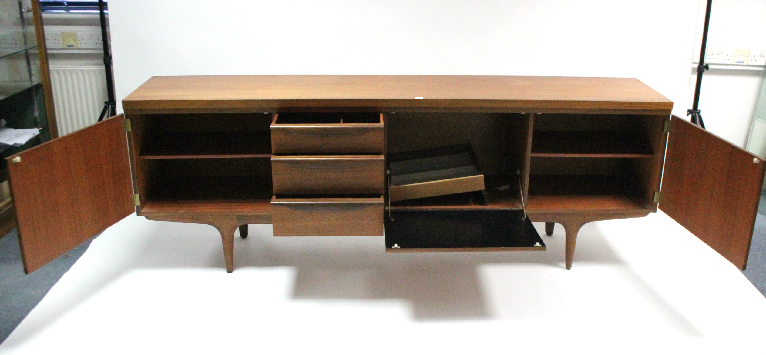 A mid-20th century large teak sideboard fitted with an arrangement of drawers & cupboards, & on - Image 6 of 7