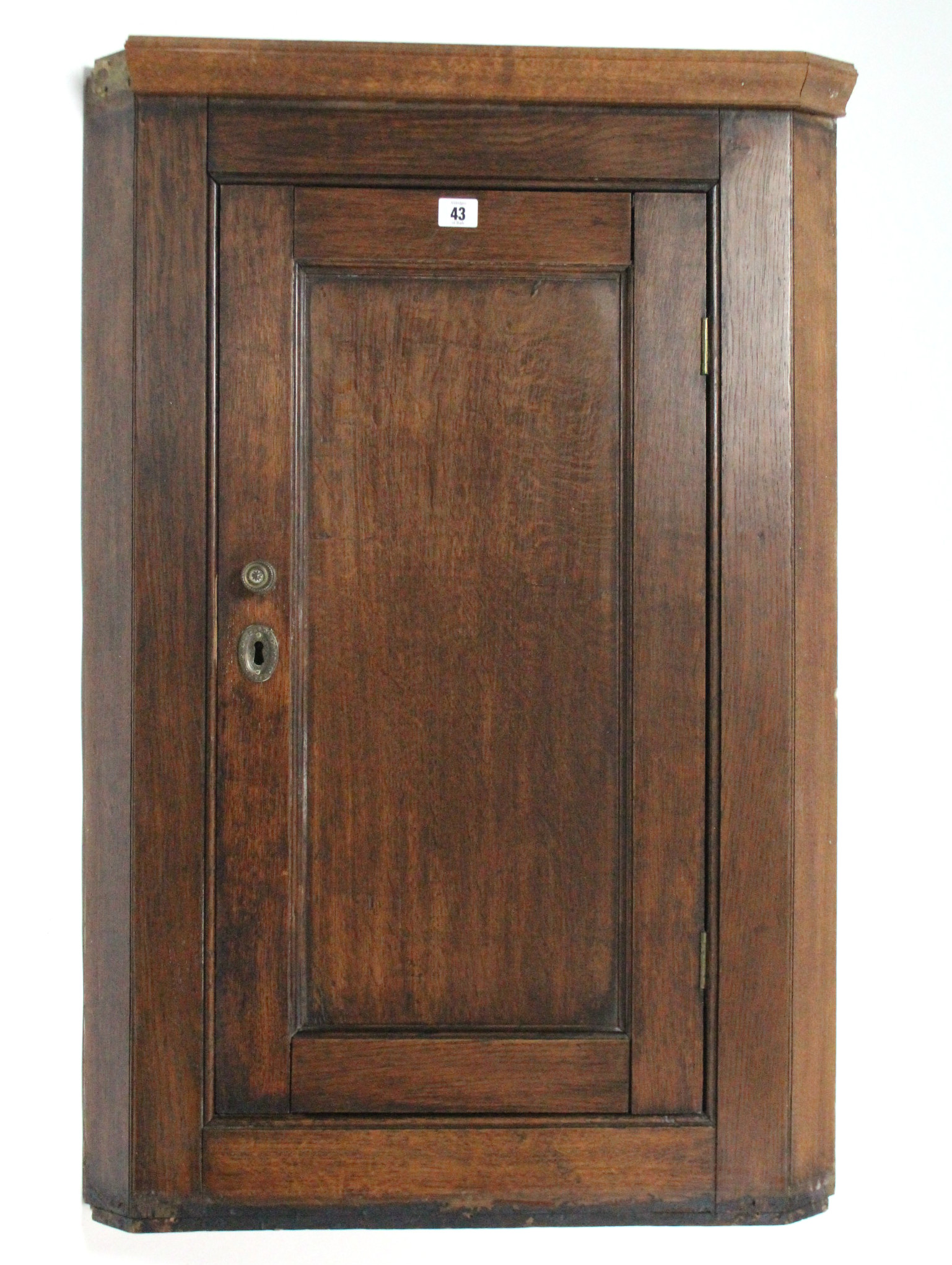 A 19th century small oak hanging corner cupboard fitted two shelves enclosed by panel door, 26" wide