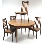 A 1970’s teak circular extending dining table with centre leaf, & on four round tapered legs, 48”