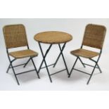 An iron & woven cane folding garden table with circular top, 24” diam; & a ditto pair of folding