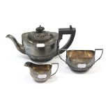 A George V small silver three-piece tea set of oval semi-fluted design, Birmingham 1915.