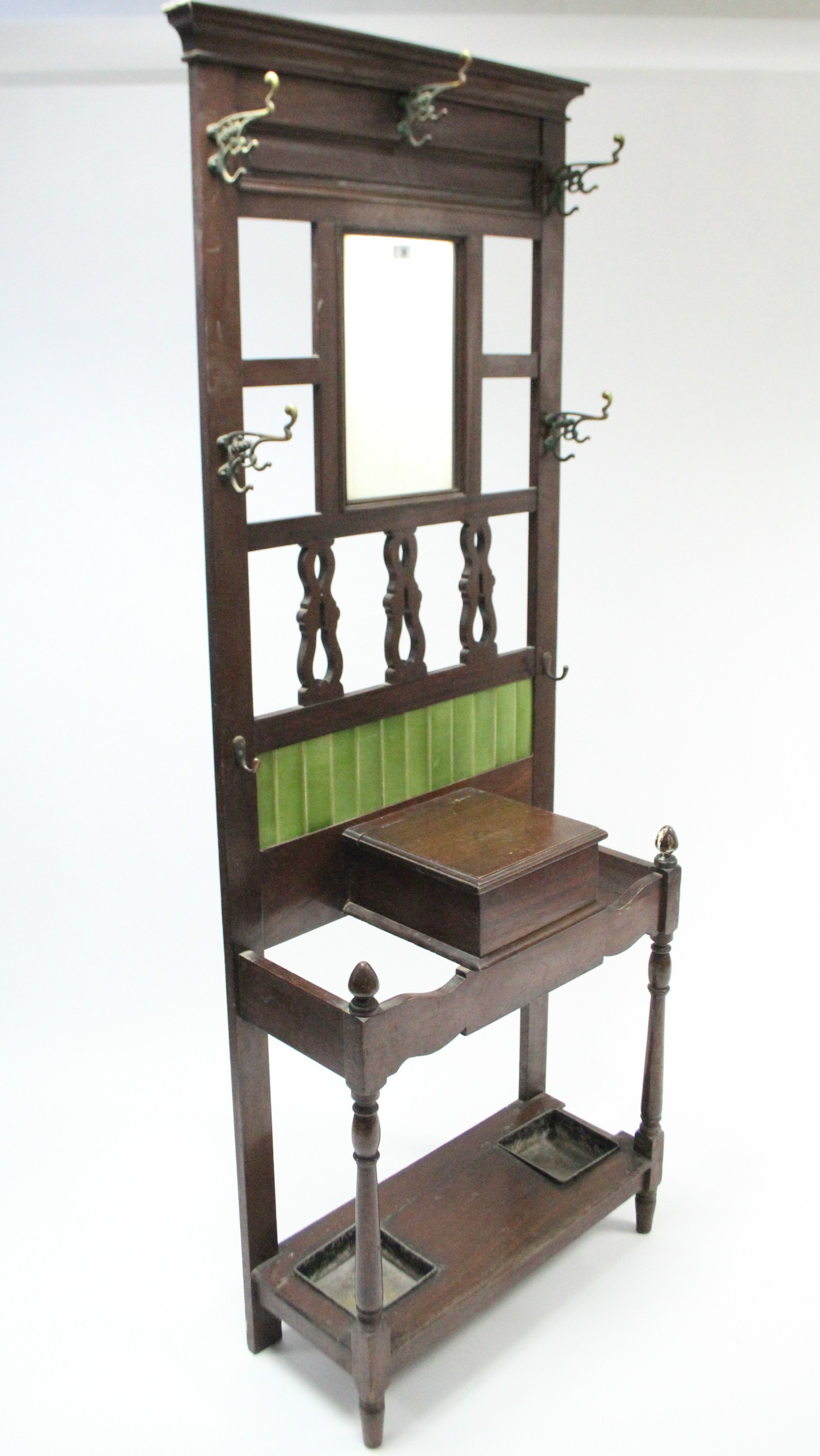 A Victorian walnut hallstand, inset rectangular mirror above a glove compartment, & on baluster-