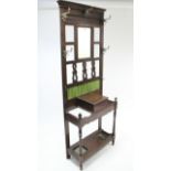 A Victorian walnut hallstand, inset rectangular mirror above a glove compartment, & on baluster-