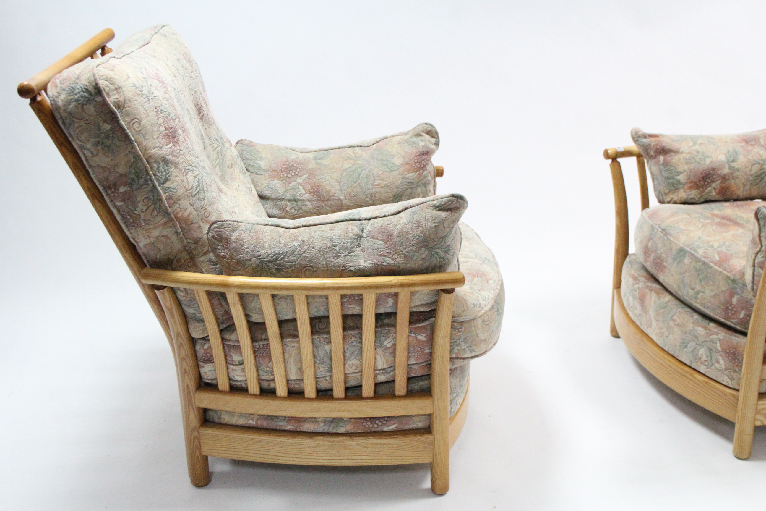 A pair of Ercol light elm frame armchairs with loose cushions to the seats & backs, & on short round - Image 2 of 4