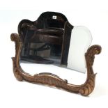 An early 20th century shaped bevelled wall mirror with gilt gesso scroll frame to the lower part,