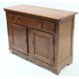 A dwarf cabinet fitted long frieze drawer above cupboard enclosed by pair of panel doors, & on