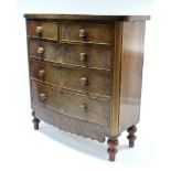 A Victorian mahogany bow-front chest, fitted two short & three long graduated drawers with turned