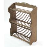 A pine standing plate rack with shaped end supports, 25¾” wide.