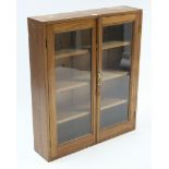 A mahogany bookcase fitted three shelves enclosed by pair of glazed doors, 41¾” wide x 37¾” high.