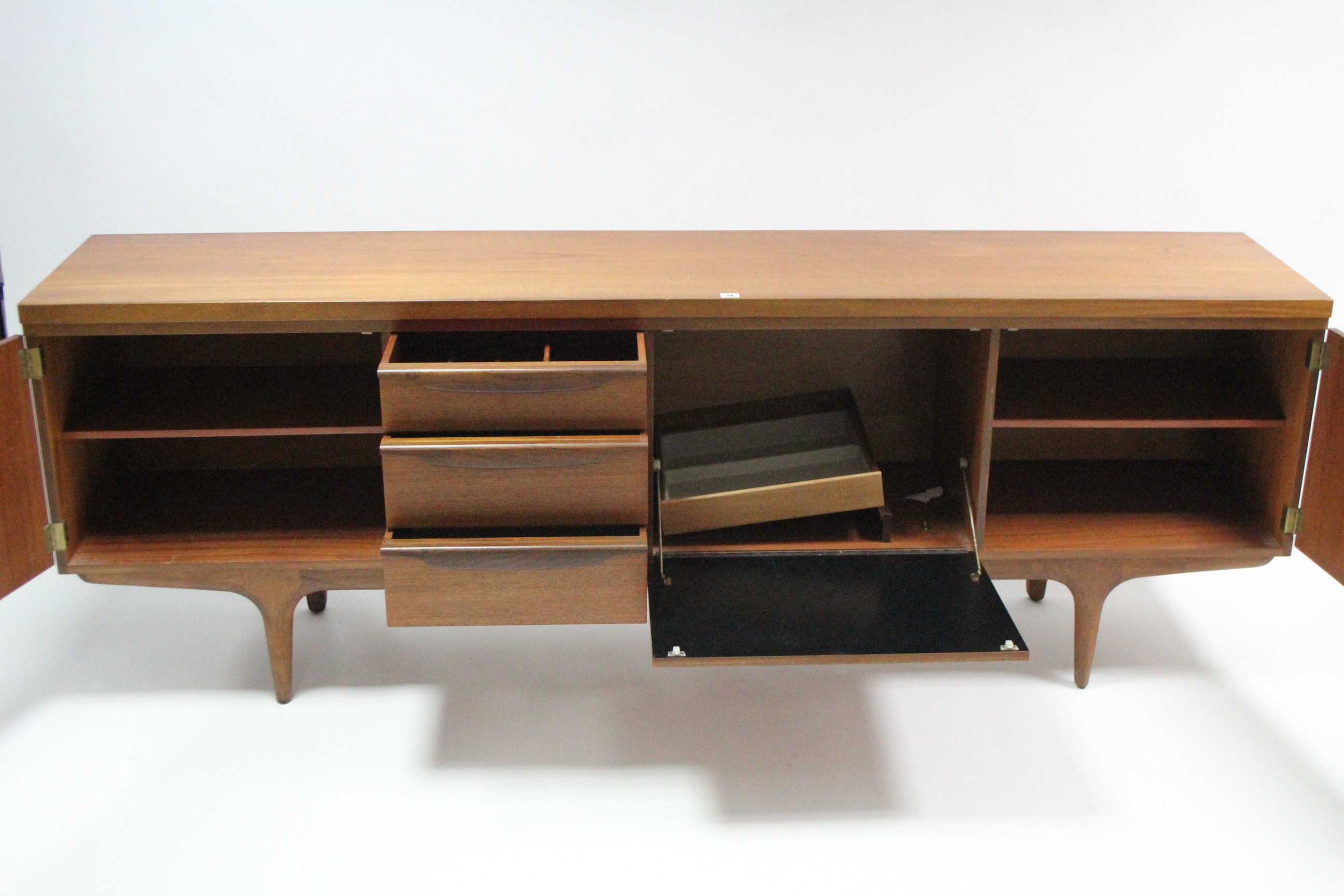 A mid-20th century large teak sideboard fitted with an arrangement of drawers & cupboards, & on - Image 2 of 7