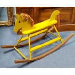 A yellow painted wood rocking horse, 23” high; & a carved beech dressing table stool.