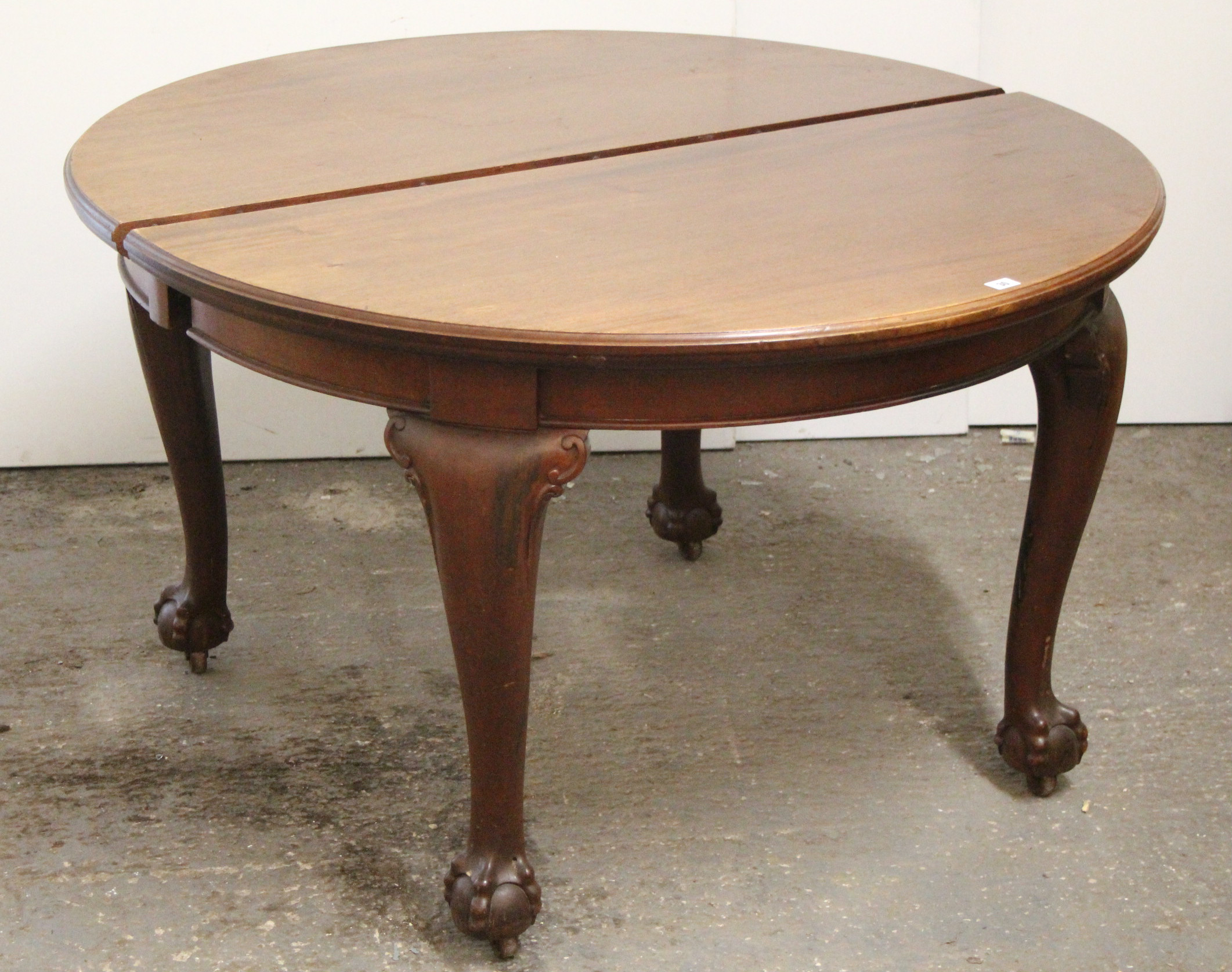 A late 19th/early 20th century mahogany oval extending dining table with three additional leaves,