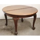 A late 19th/early 20th century mahogany oval extending dining table with three additional leaves,