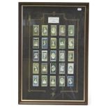 A display of John Player cigarette cards; together with twelve small coloured prints; a pair of