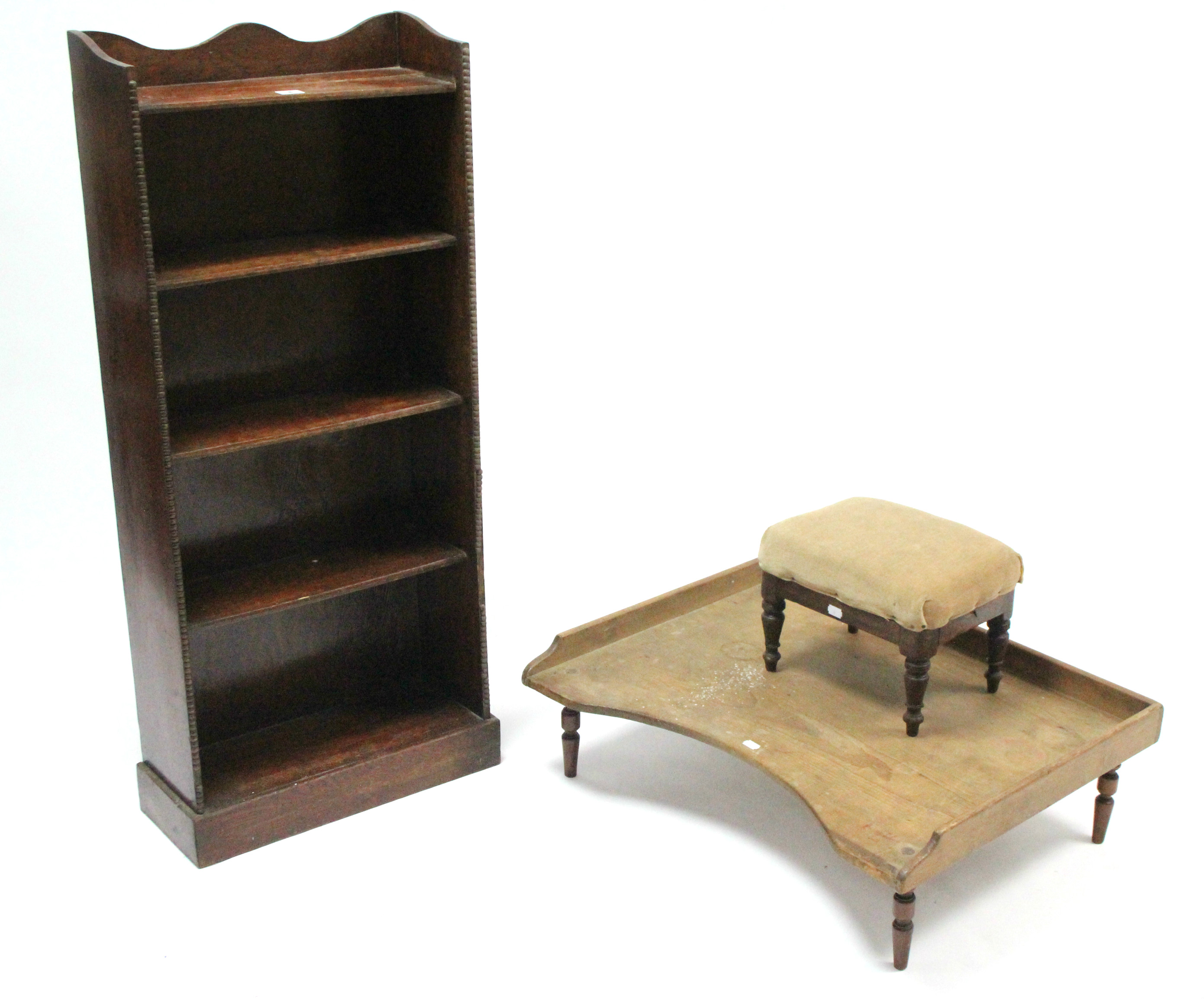 A 1930's oak standing five tier open bookcase, 18" wide x 42" high; together with a pine bed tray; &