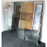 A large rectangular frameless wall mirror made up of thirteen rectangular mirrored plates, 59” x 75”