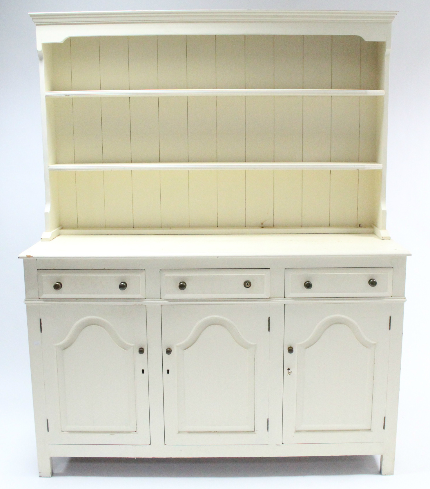 A cream painted pine dresser, the upper part fitted two open shelves & with panelled back, the