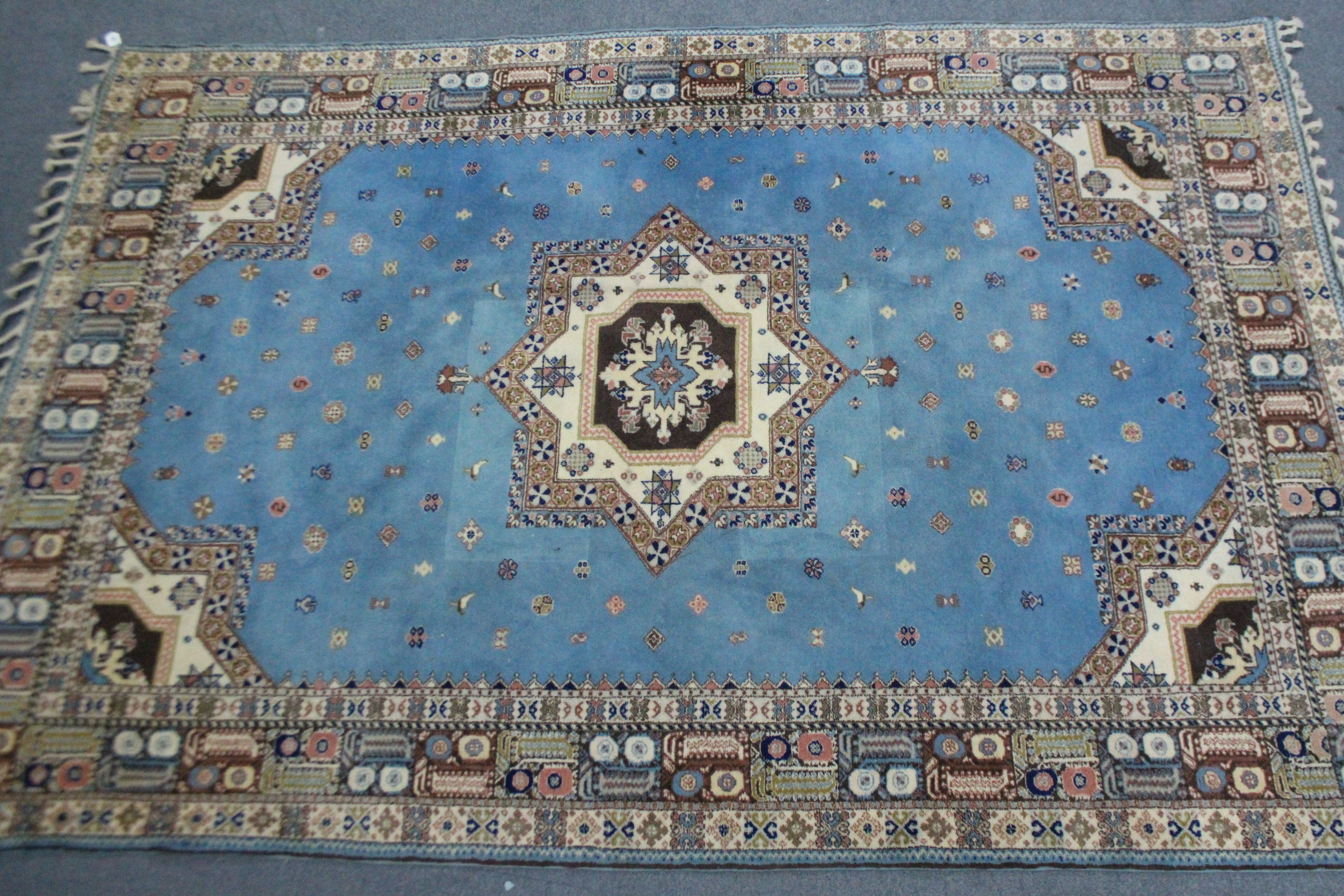 A Persian pattern small carpet of pale blue & ivory ground, with multi-coloured geometric design