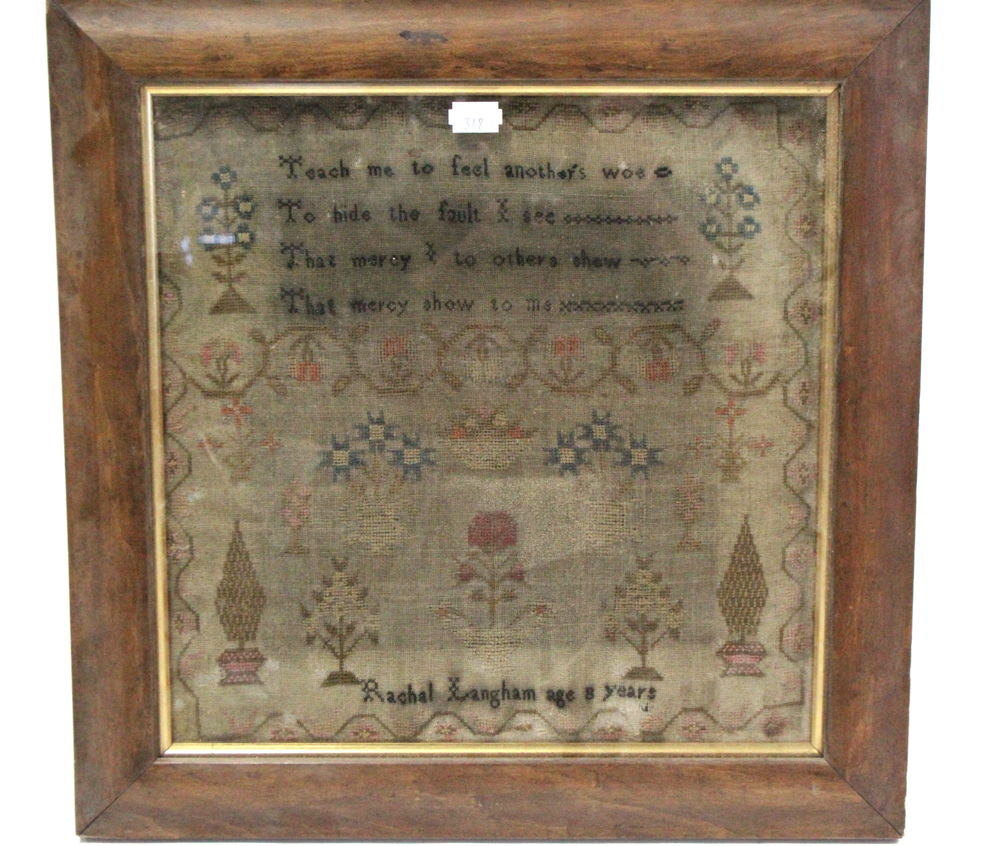 An antique woolwork embroidered sampler with verse to top & inscribed: “Rachel Langham age 8 years”,