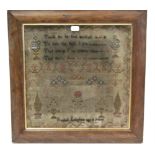 An antique woolwork embroidered sampler with verse to top & inscribed: “Rachel Langham age 8 years”,