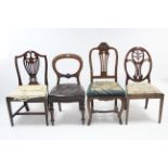 A Victorian carved mahogany balloon-back dining chair with buttoned leather seat, & on turned