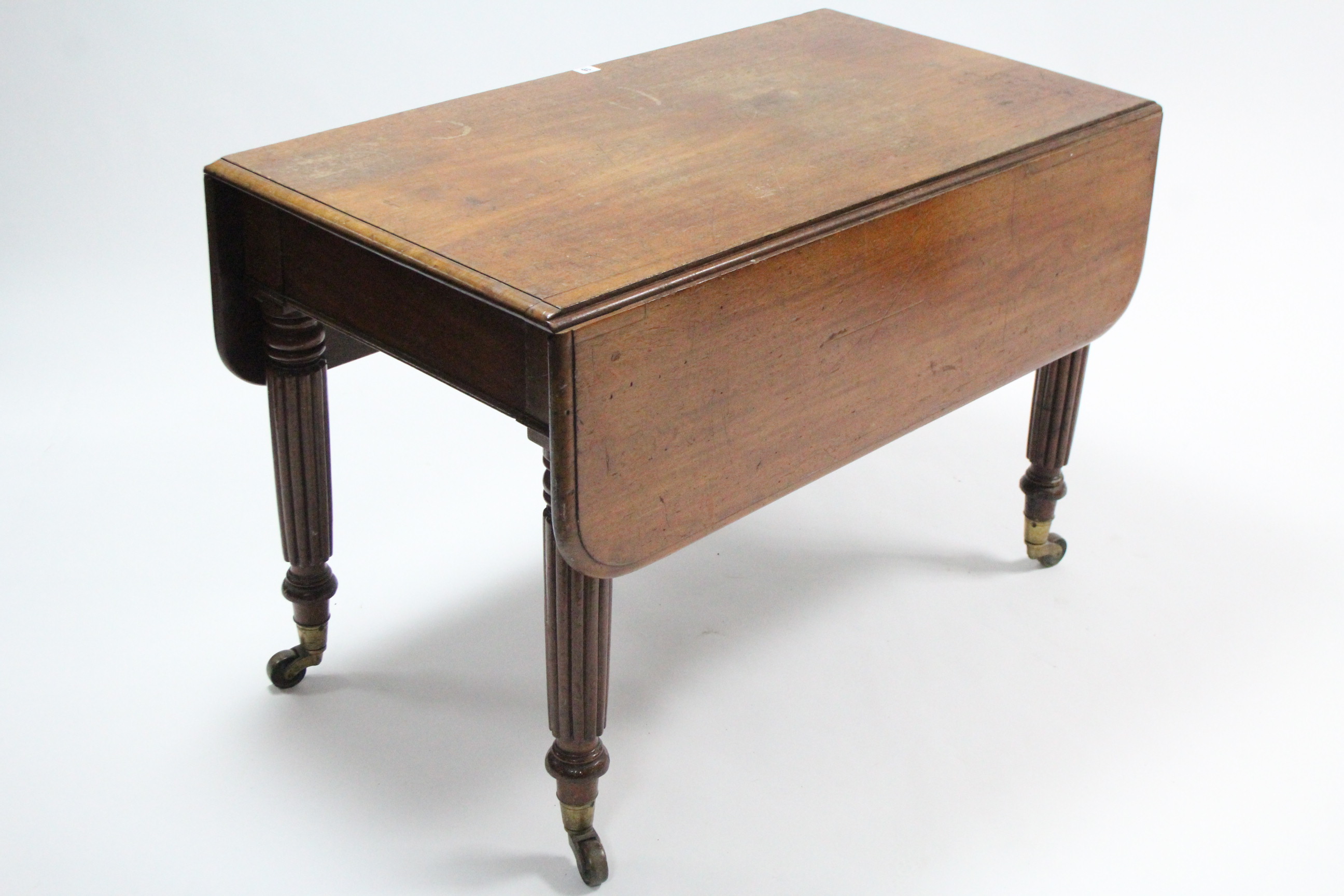 A 19th century mahogany Pembroke table fitted end drawer, & on fluted & turned tapered legs with