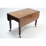 A 19th century mahogany Pembroke table fitted end drawer, & on fluted & turned tapered legs with