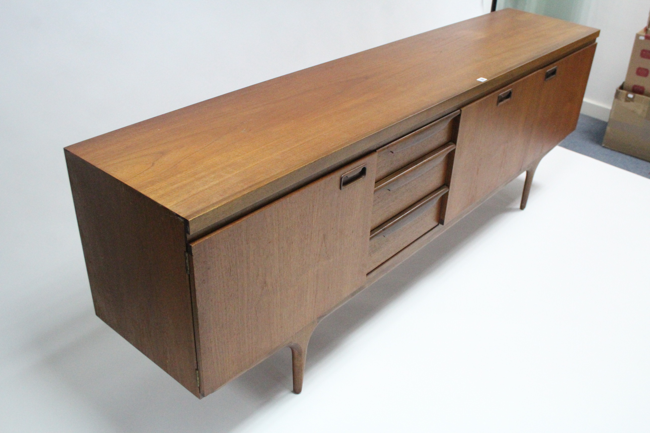 A mid-20th century large teak sideboard fitted with an arrangement of drawers & cupboards, & on - Image 4 of 7