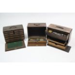 Three early 20th century wooden tool chests containing numerous engineer’s tools.