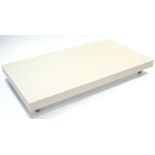 A Natuzzi (Italian) pale cream lacquered rectangular low coffee table, on chrome finish short square