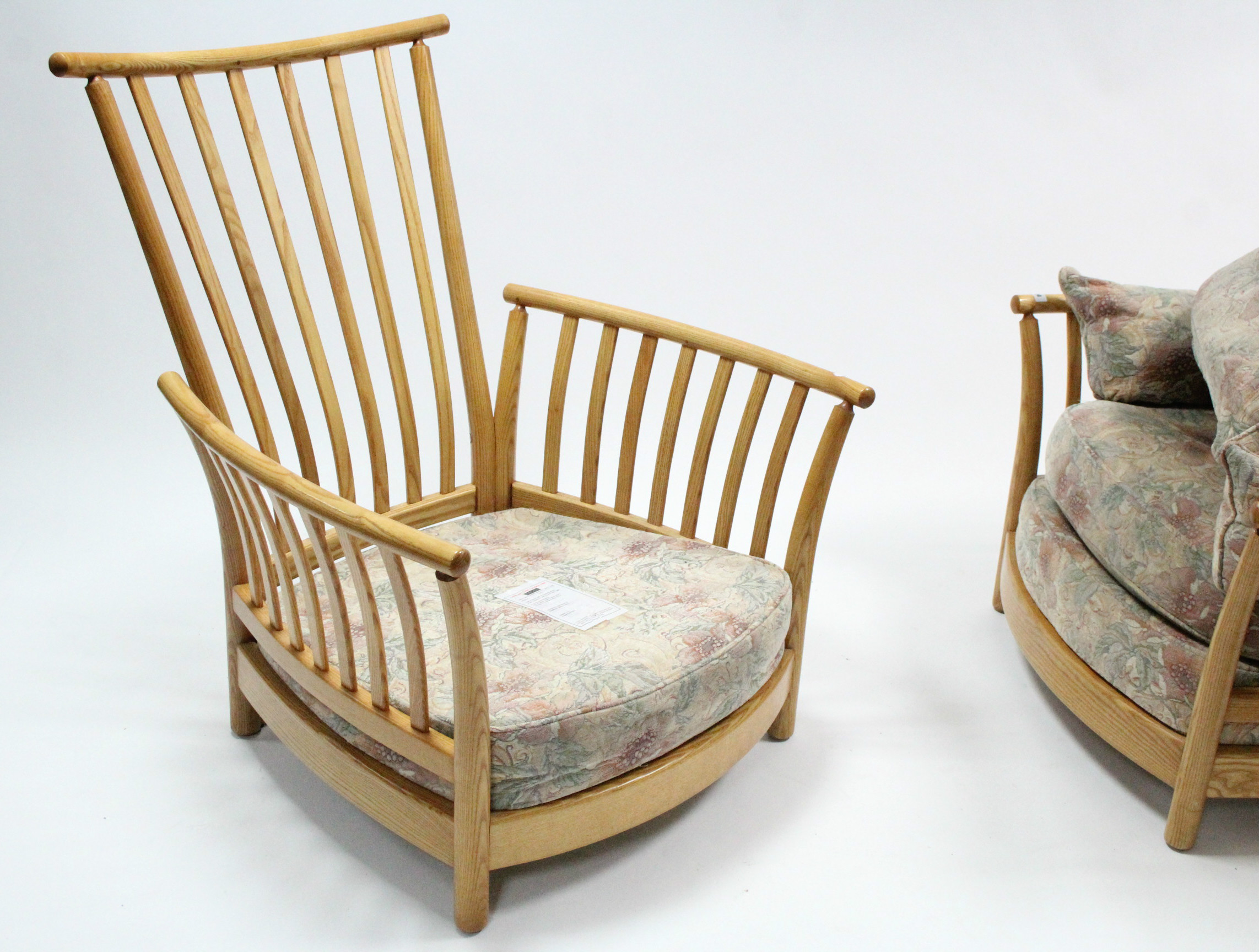 A pair of Ercol light elm frame armchairs with loose cushions to the seats & backs, & on short round - Image 3 of 4