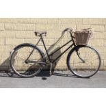 A mid-20th century Phillips (black) ladies’ bicycle, fitted with two baskets.