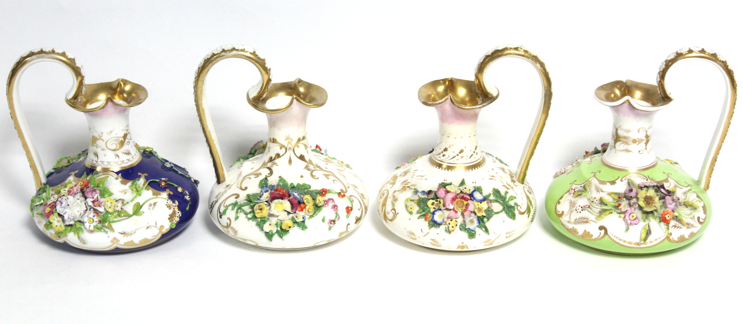 A pair of 19th century Bloor Derby porcelain squat round ewers with floral-encrusted decoration on a