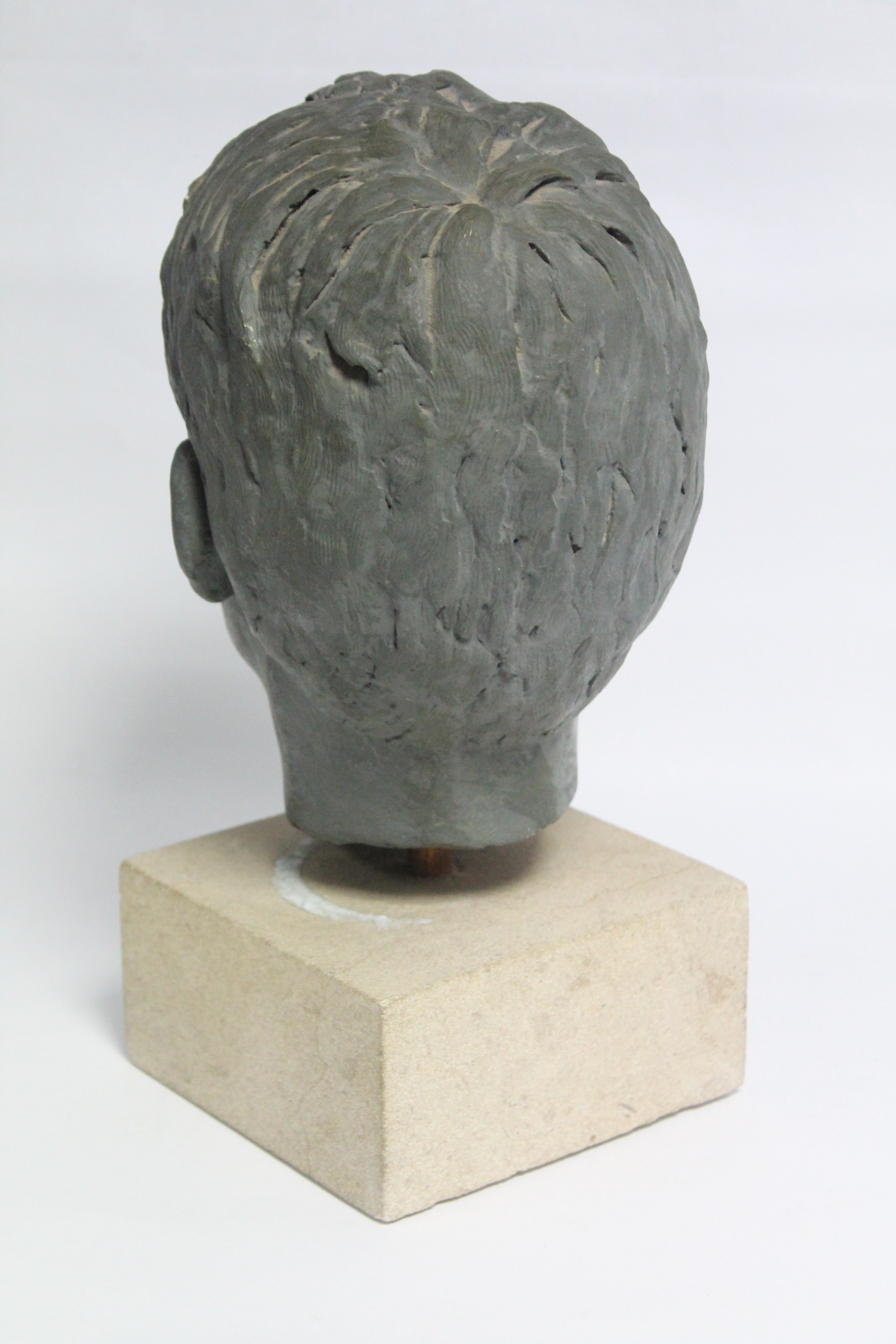 A green painted plaster head of a young boy, on stone block base; 13½” high over-all. - Image 4 of 4