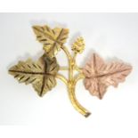 An un-marked three-colour metal leaf spray brooch.