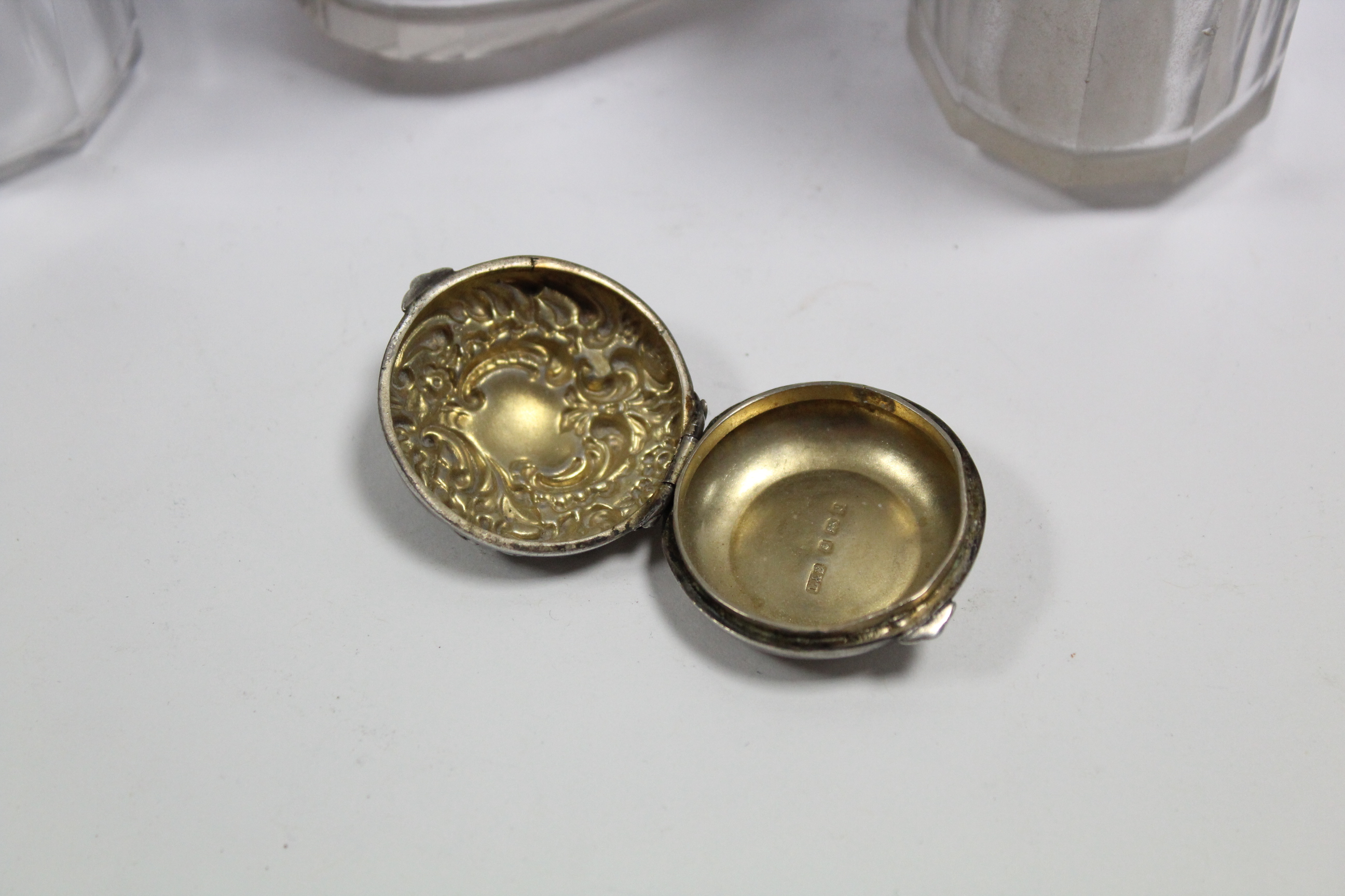 An Edwardian circular pill box with embossed hinged lid, Birmingham 1902; & four cut glass - Image 2 of 4