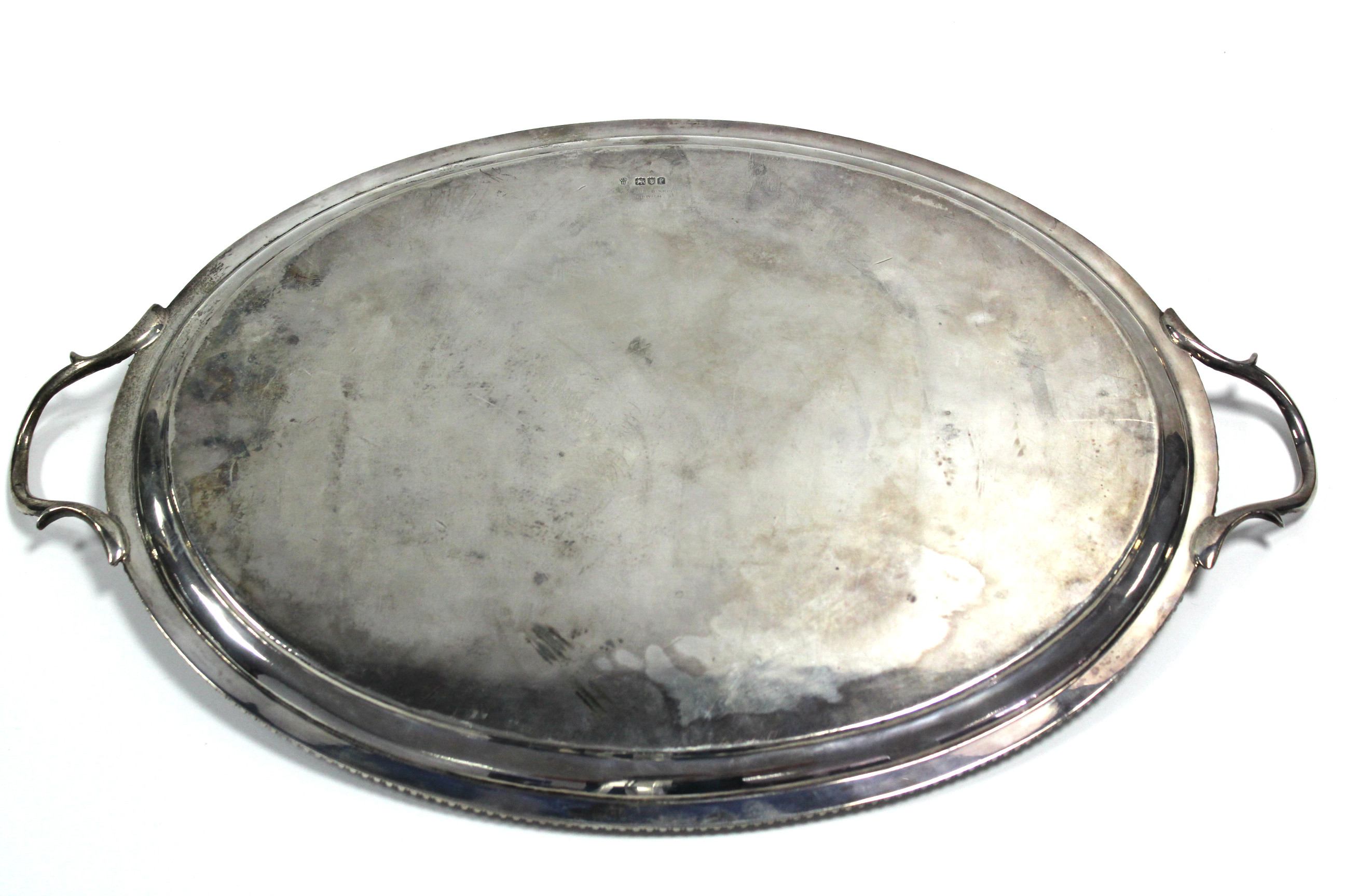 An Edwardian oval two-handled tray with floral-engraved wide border & gadrooned rim, 22” x 14”, - Bild 2 aus 3