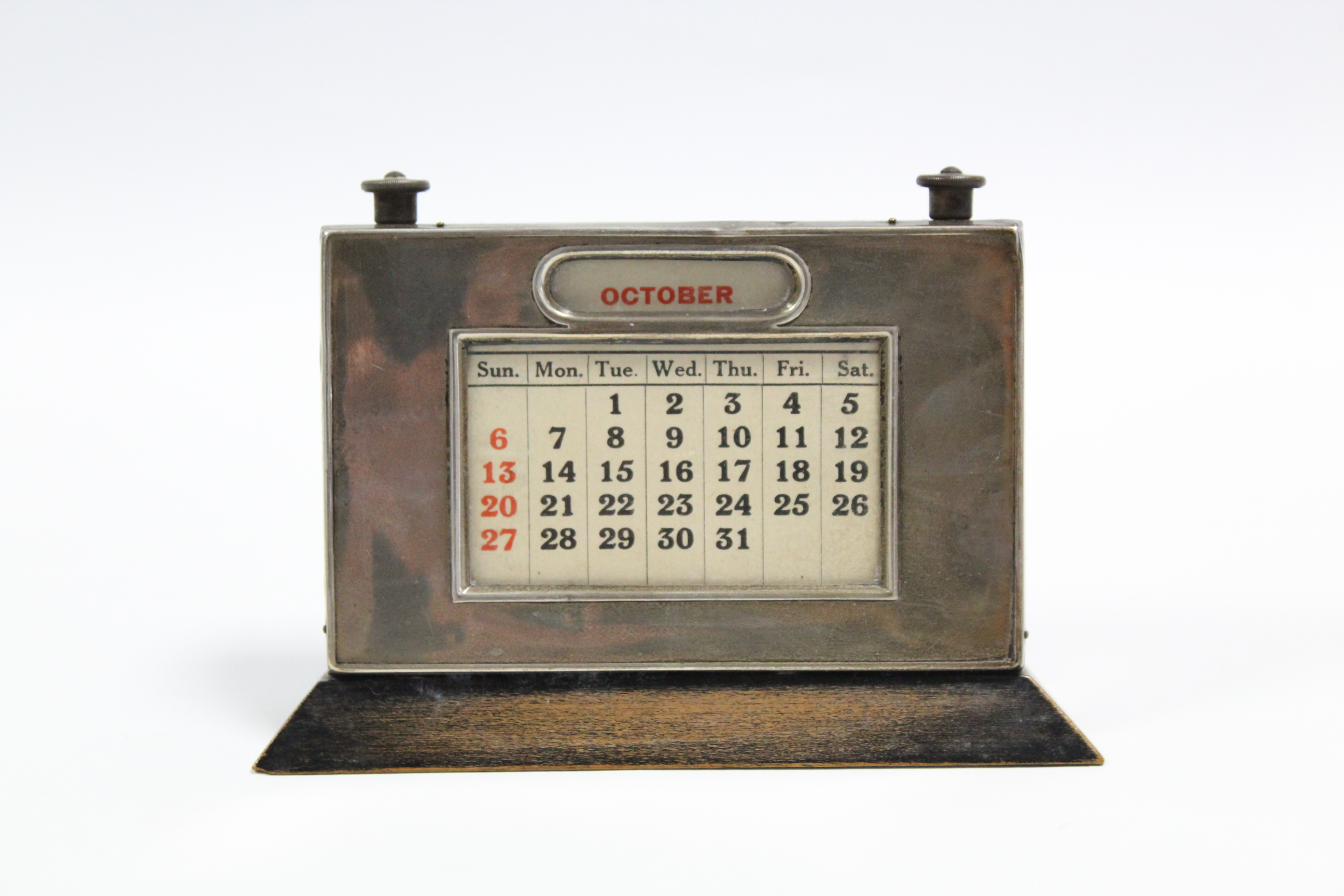 A George V silver-mounted perpetual desk calendar, 5” wide x 3½” high, Birmingham 1930; a small