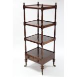 An early 19th century mahogany four-tier whatnot on slender ring-turned supports, fitted drawer to