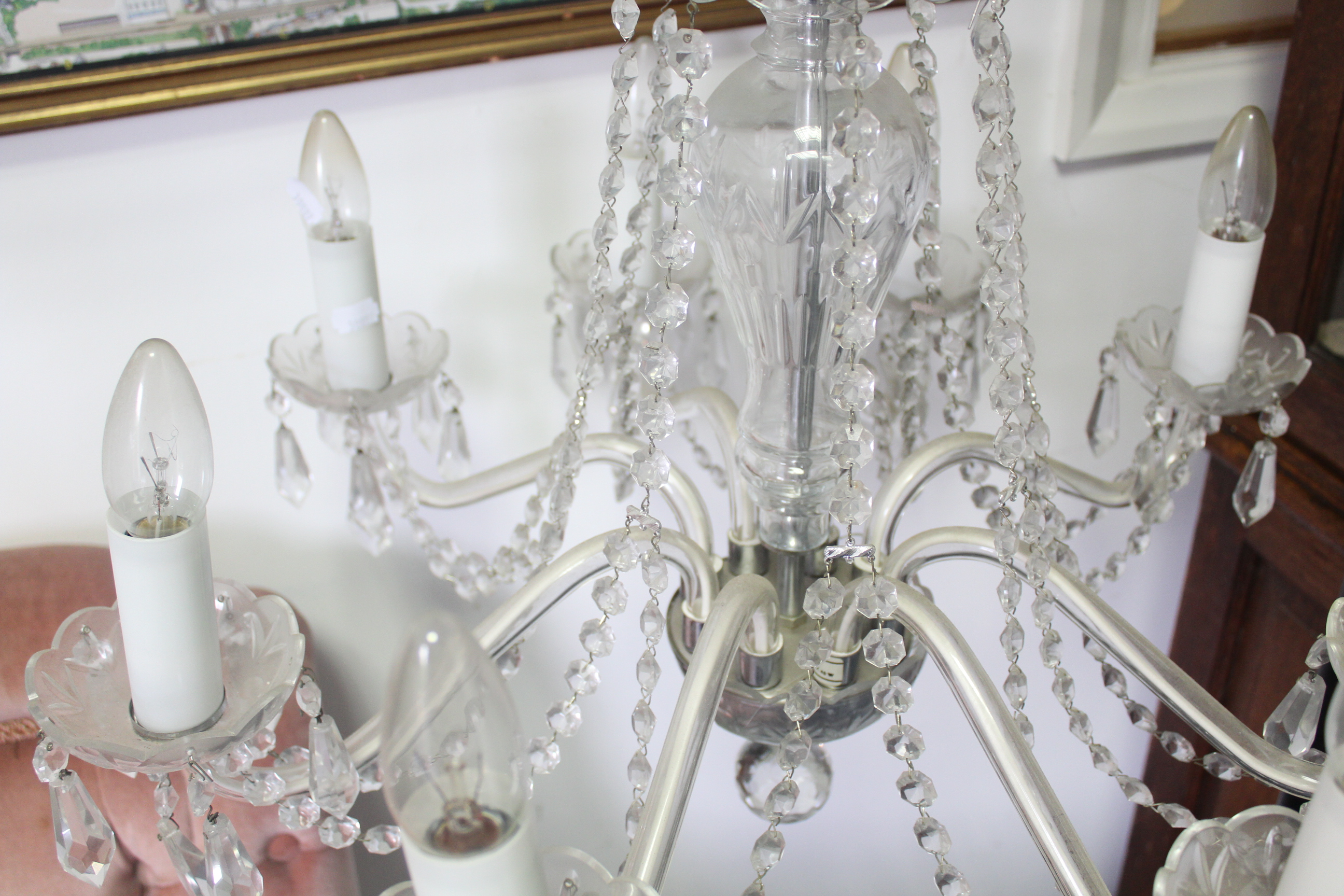 A cut glass chandelier with eight scroll arms with pendant prism drops, the slender baluster - Image 3 of 5