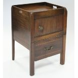 A George III mahogany tray-top commode with pierced handles, the pot cupboard enclosed by tambour