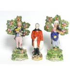 A pair of early 19th century Staffordshire pottery male & female standing bocage figures, each