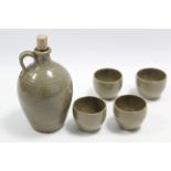 A Muchelney studio pottery cider flagon with specked olive glaze, 7¼” high; & four matching