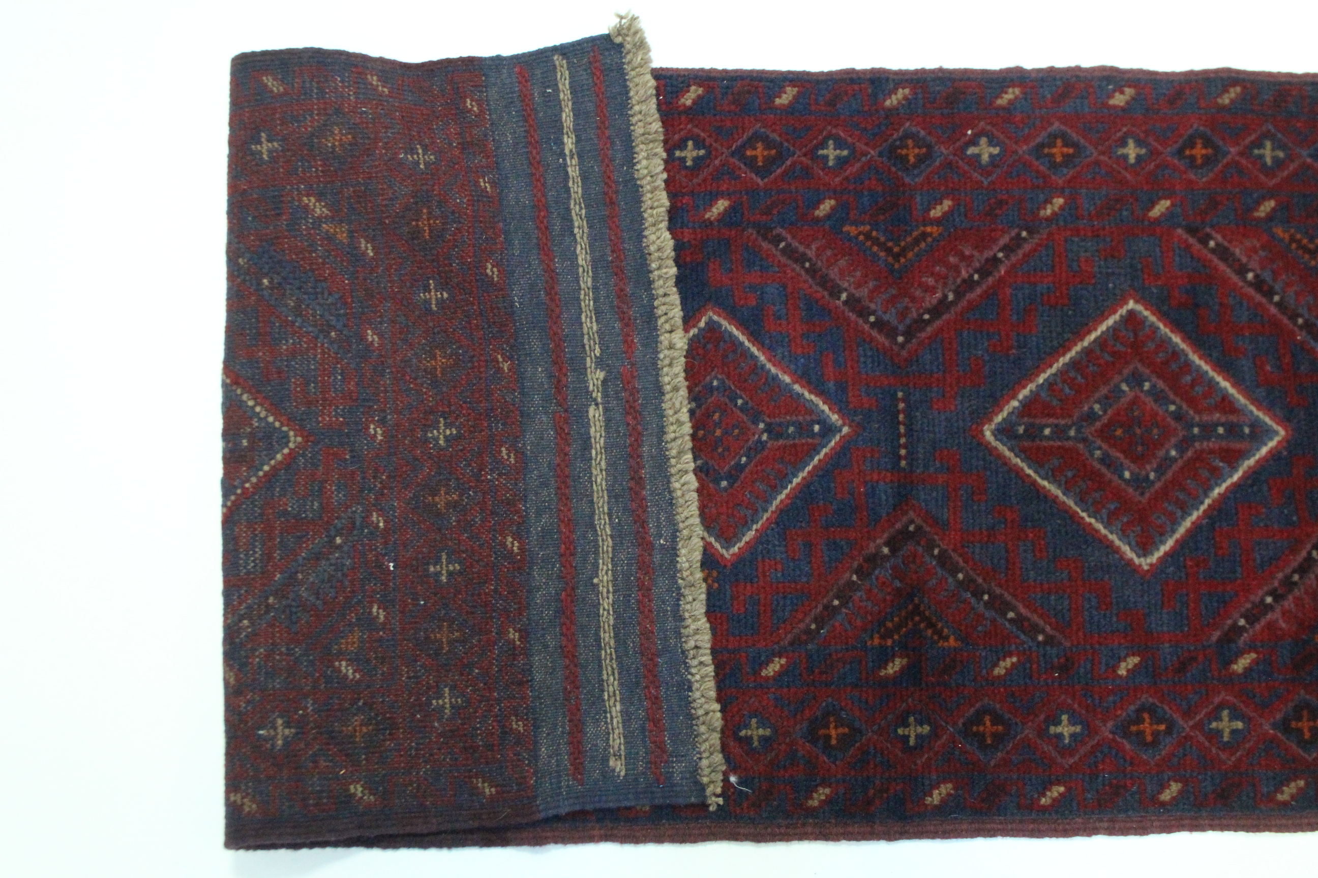 A Meshwari runner of dark blue, & red ground with all over repeating geometric lozenge design; 26" x - Image 2 of 2