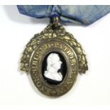 A 19th century London Pitt Club member’s badge, the silver-gilt oval medal inset “Tassie” glass