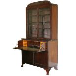 A regency mahogany secretaire bookcase with rounded cornice, fitted three adjustable shelves