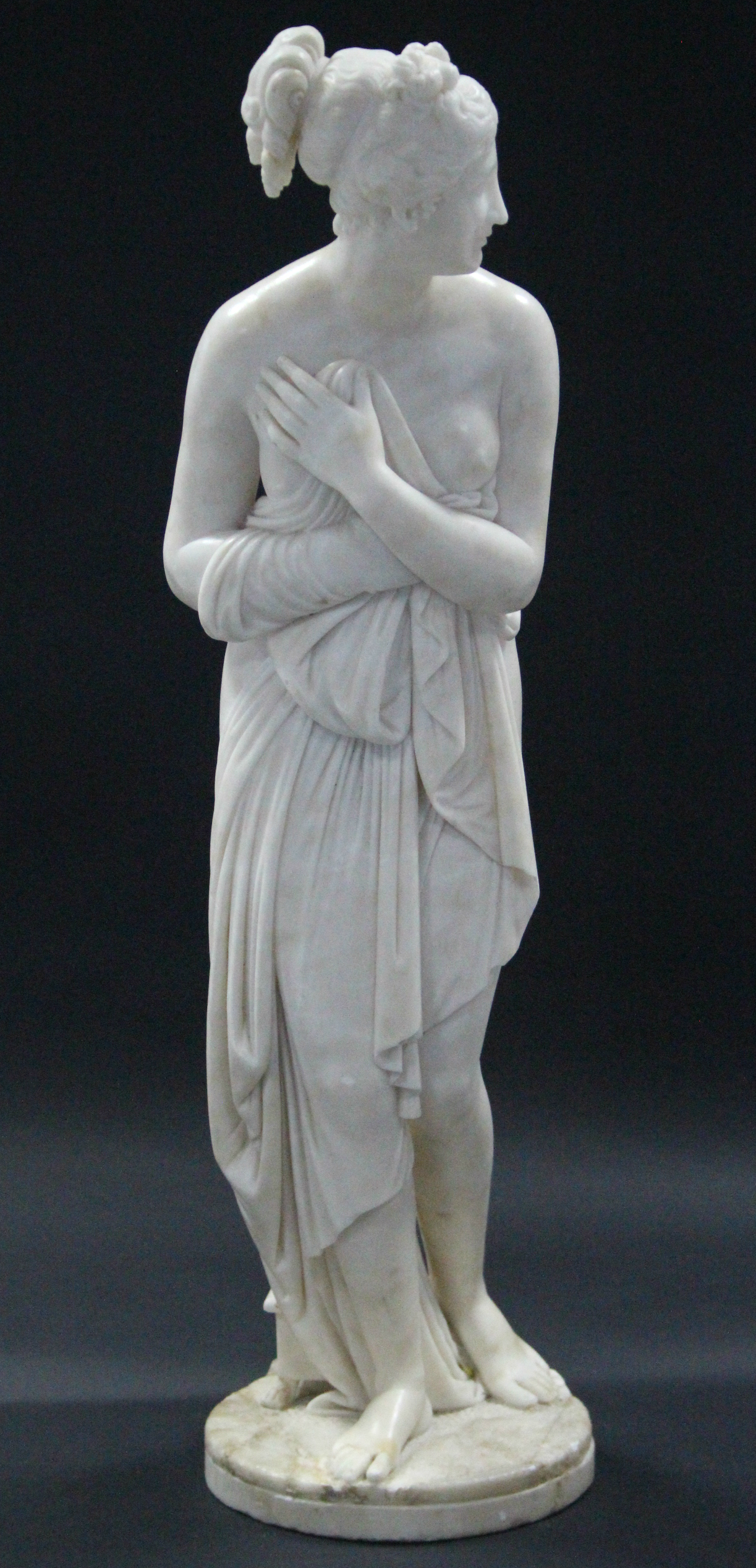 A 19th century WHITE MARBLE SCULPTURE OF THE VENUS ITALICA, after the antique, on flat circular