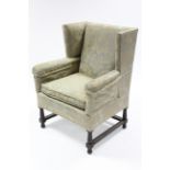 A 19th century square wing-back armchair upholstered green floral silk damask, with cushion