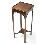 A George III style mahogany urn stand with pull-out slide below the square top, on slender square